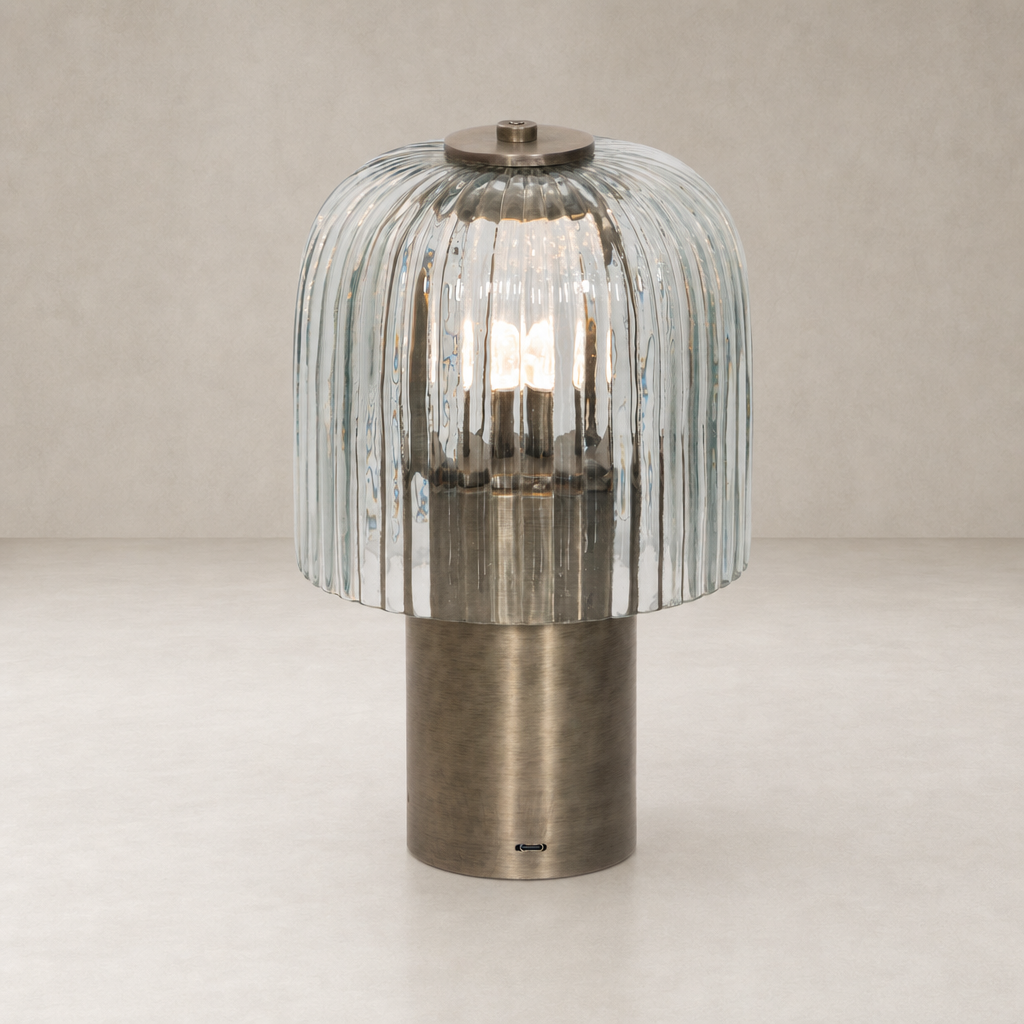 Cordless table lamp with a ribbed glass shade and antique nickel base.