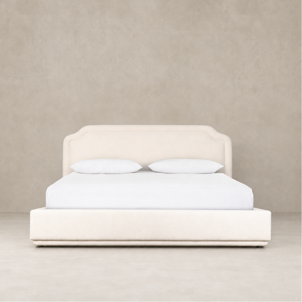 Elegant bed in Laughlin Bone upholstery with curved headboard and minimalist design.