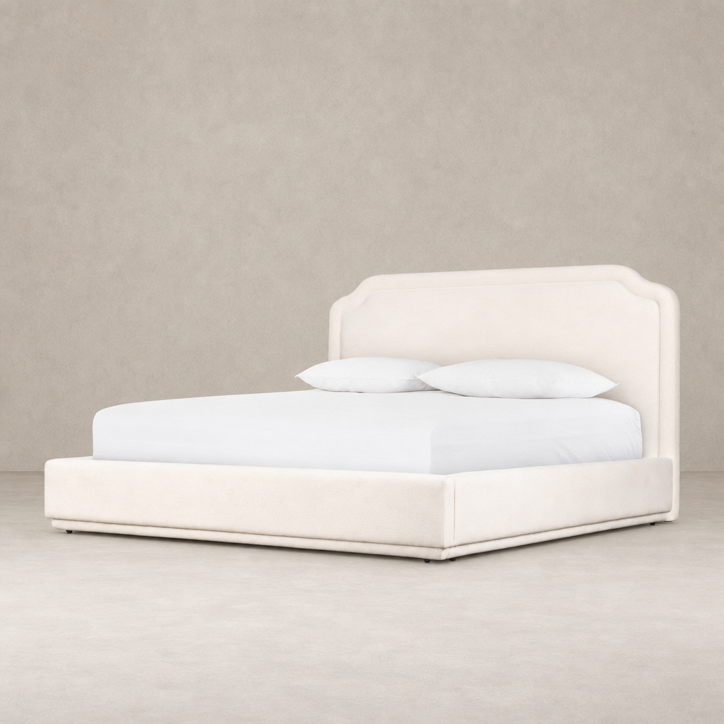 Elegant Laughlin Bone bed with a curved headboard and plush upholstery.