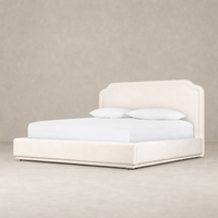 Elegant Laughlin Bone bed with a curved headboard and plush upholstery.