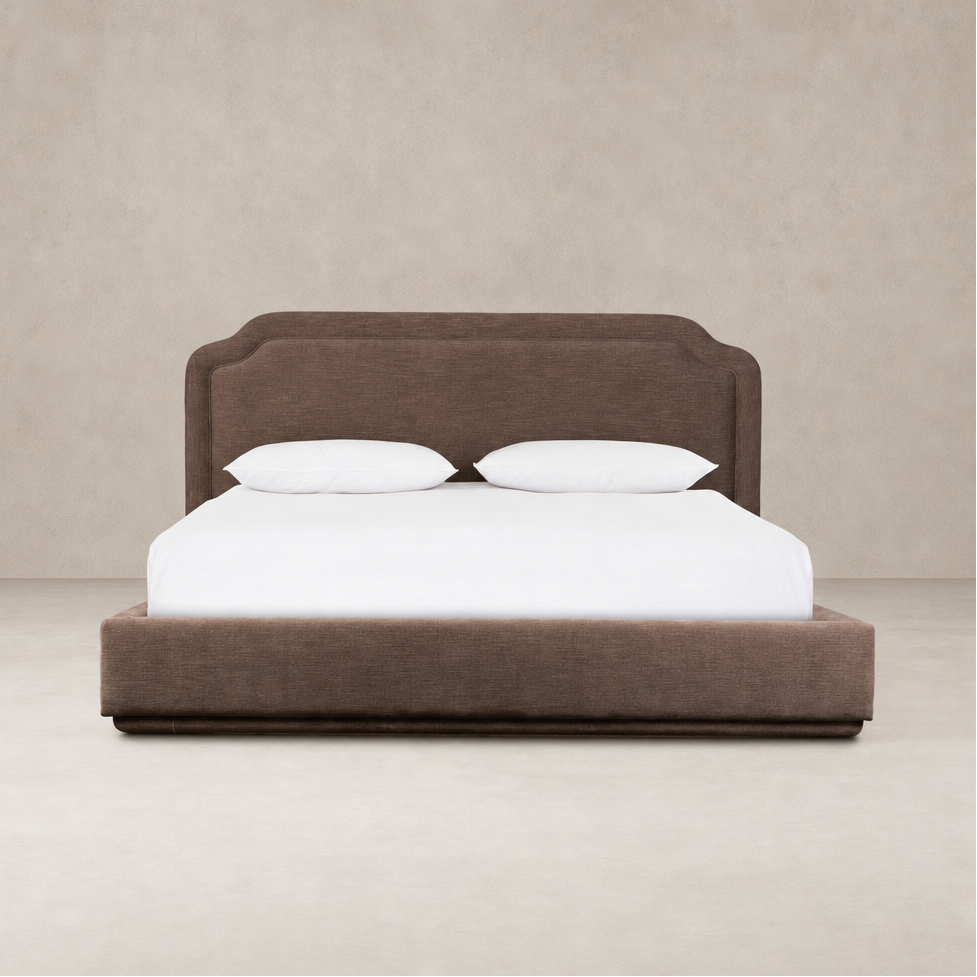 Elegant bed in Laughlin Cafe upholstery with a scalloped headboard and sleek design.