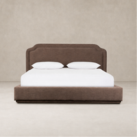 Elegant bed in Laughlin Cafe upholstery with a scalloped headboard and sleek design.