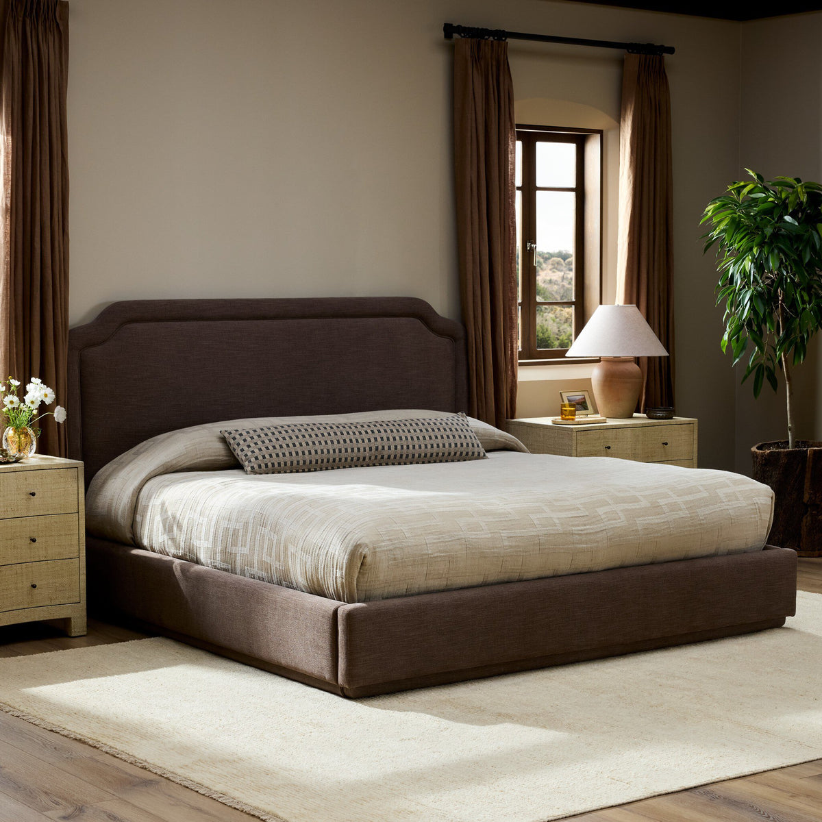 Stylish bed in Laughlin Cafe upholstery, featuring an elegant headboard and neutral bedding.
