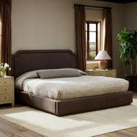 Stylish bed in Laughlin Cafe upholstery, featuring an elegant headboard and neutral bedding.