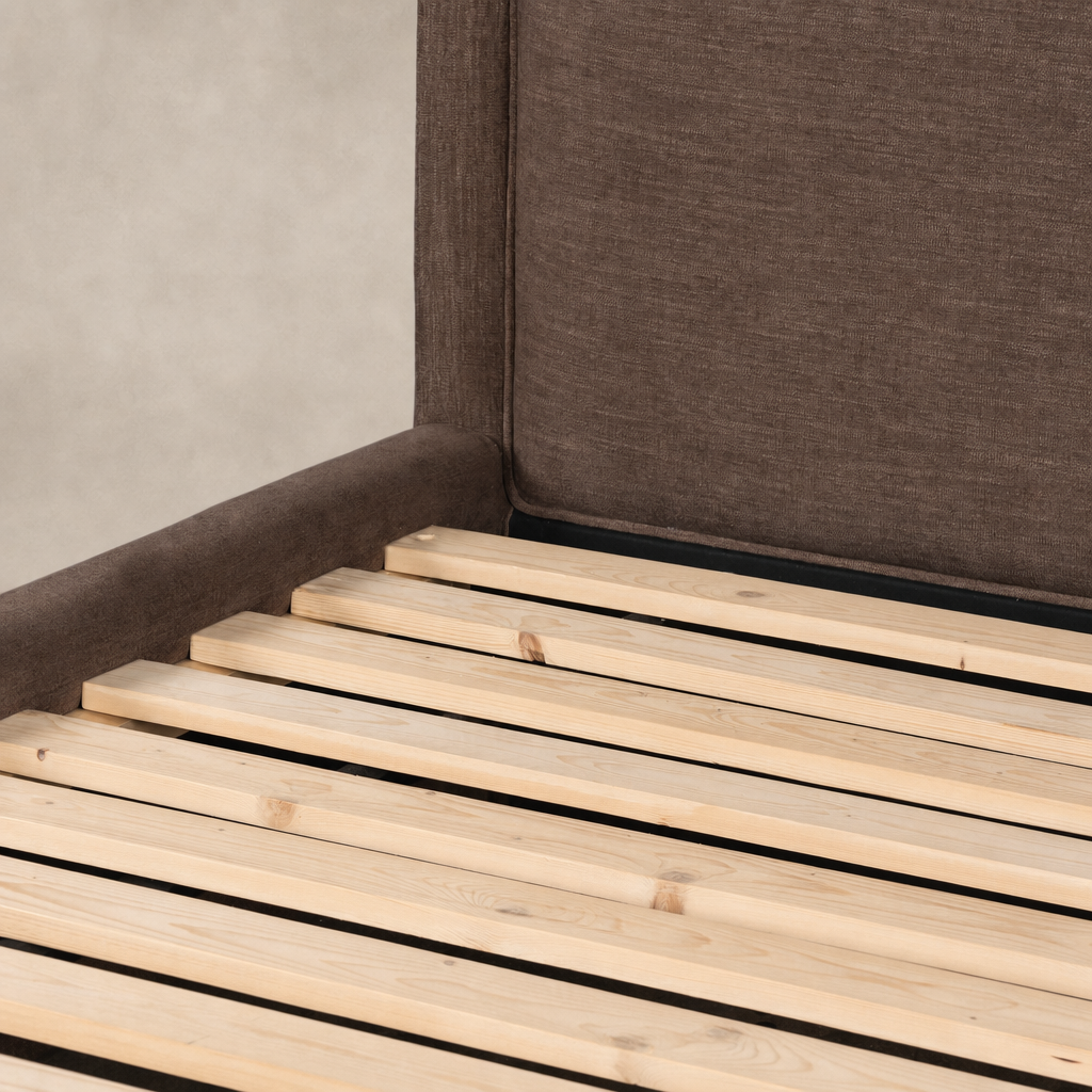 Brown upholstered bed frame featuring a high headboard and wooden slats.