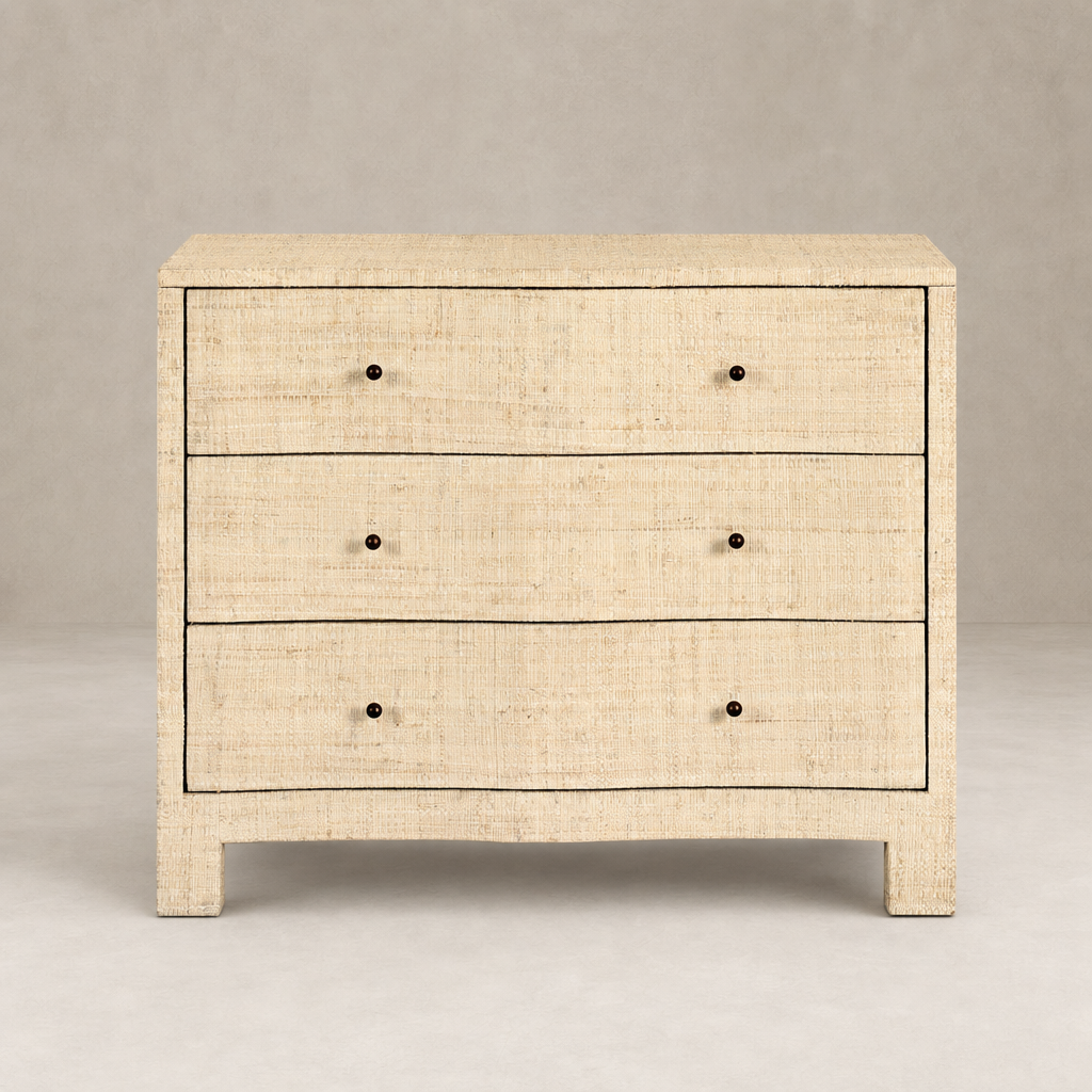 Natural fleck raffia nightstand with three spacious drawers and sleek design.