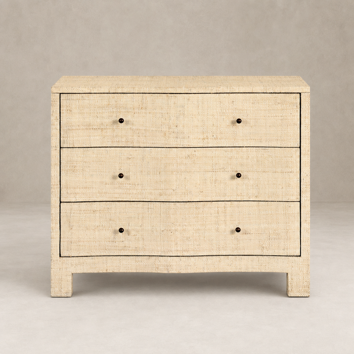Natural fleck raffia nightstand with three spacious drawers and sleek design.