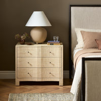 Natural Fleck Raffia nightstand featuring three drawers and minimalistic design.
