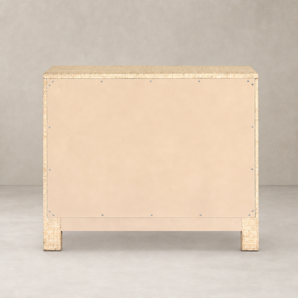 Natural Fleck Raffia nightstand with a textured surface and simple design.