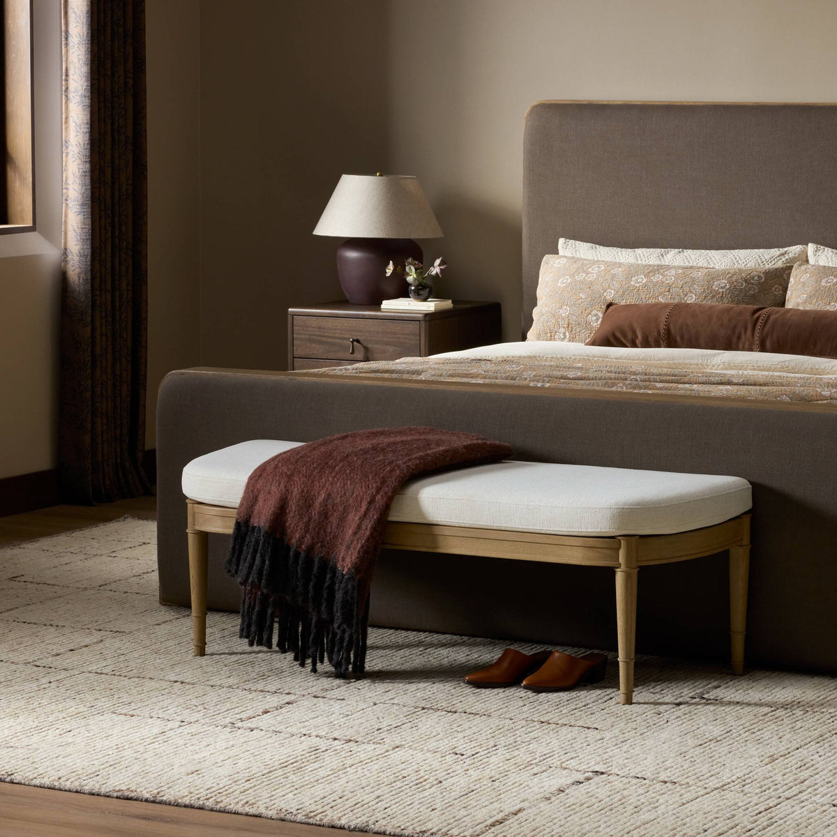 Accent bench in Crypton Nomad Snow with wood legs and a cozy throw.