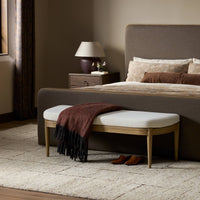 Accent bench in Crypton Nomad Snow with wood legs and a cozy throw.