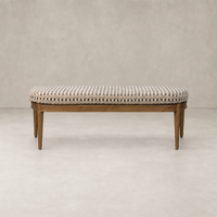 Fawn-colored accent bench with a striped upholstered seat and slender wooden legs.