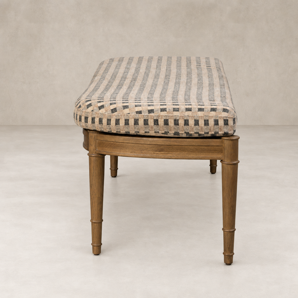 Accent bench in Firefinch Fawn with woven fabric seat and wooden legs.