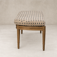 Accent bench in Firefinch Fawn with woven fabric seat and wooden legs.