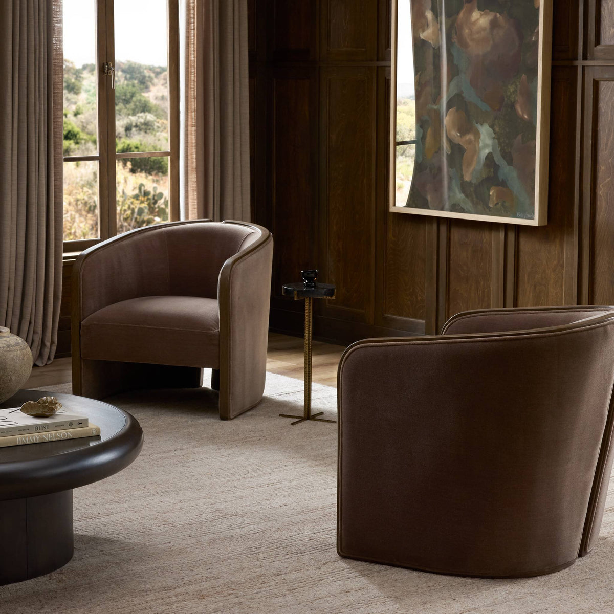 Curved accent chair in Monte Mushroom color, stylishly placed in a cozy living room.