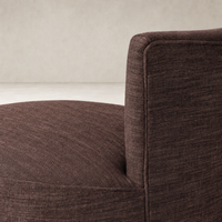 Lyra Fringe Swivel Chair in Laughlin Plum featuring textured fabric and curved silhouette.
