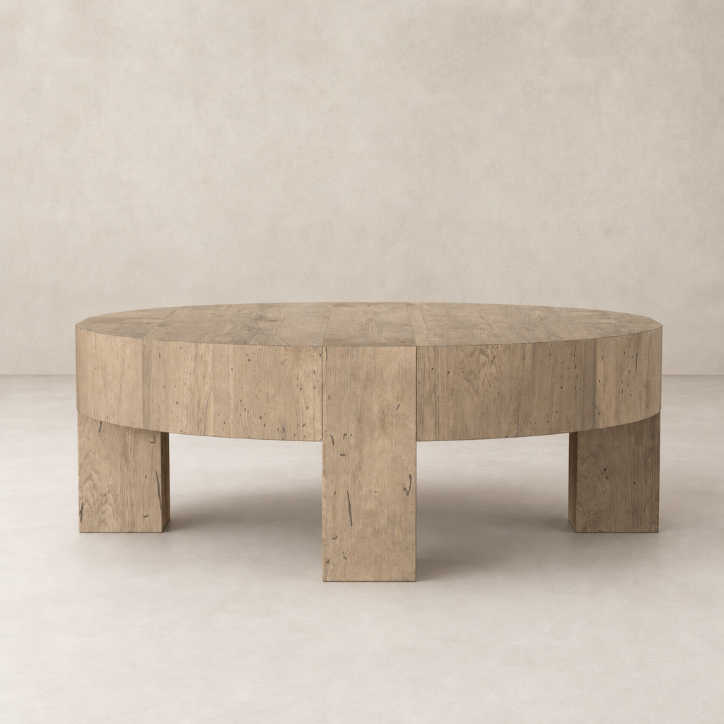 Bergen Round Coffee Table in whitewash rustic wormwood oak, featuring a smooth round top and sturdy block legs.