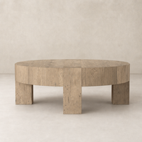 Bergen Round Coffee Table in whitewash rustic wormwood oak, featuring a smooth round top and sturdy block legs.