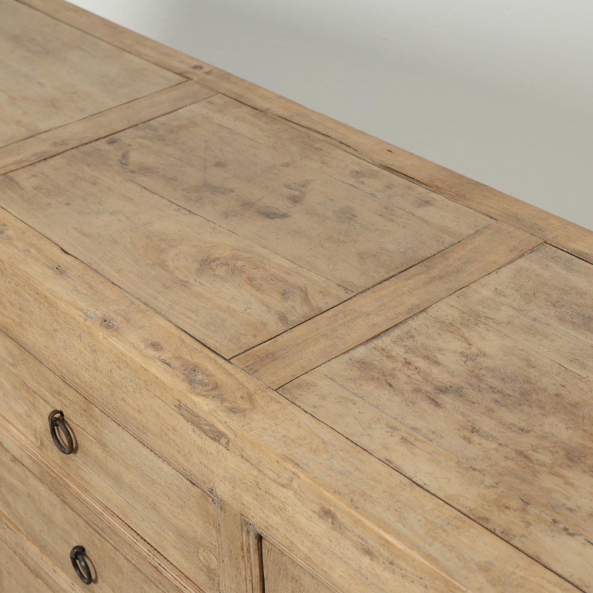 Detail of the Bruna Weathered Sideboard showcasing its rustic wood finish and natural grain patterns.