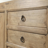 Close-up of the Bruna Weathered Sideboard showcasing its rustic wood finish and stylish metal hardware.