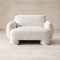 Front view of the Elba Accent Chair showcasing its soft, rounded design and textured fabric.