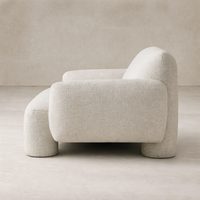 Side view of the Elba Accent Chair showcasing its soft, rounded design and textured fabric finish.