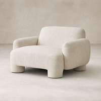 Front view of the Elba Accent Chair in soft, textured fabric, featuring rounded arms and a cozy silhouette.