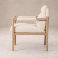 Side view of the Sorrento Dining Chair showcasing its natural wood frame and soft cream upholstery.