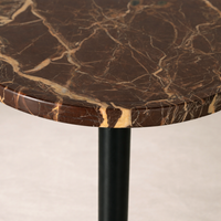 Close-up of the Wren Accent Table showcasing its rich marble top and sleek black base.