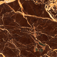Close-up of the Wren Accent Table's rich brown marble top with striking gold veining.