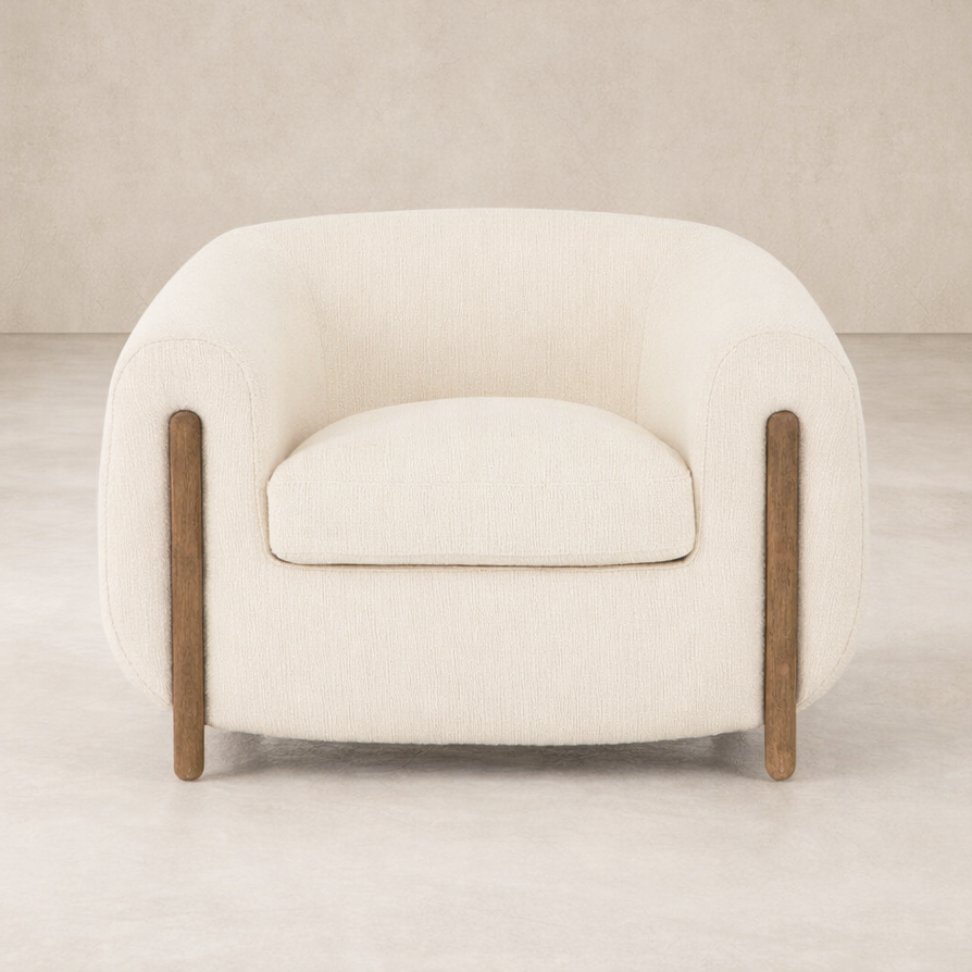 Front view of the Laurel Accent Chair, featuring soft upholstery and sleek wooden legs.