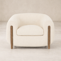 Front view of the Laurel Accent Chair, featuring soft upholstery and sleek wooden legs.