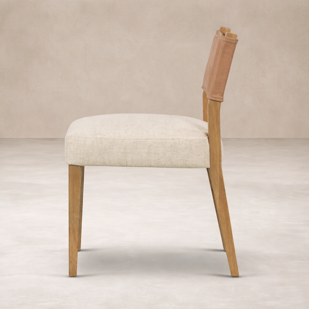 Side angle of the Roseto Dining Chair featuring a soft fabric seat and wooden legs for a modern look.