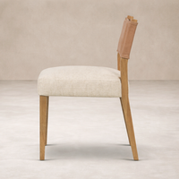 Side angle of the Roseto Dining Chair featuring a soft fabric seat and wooden legs for a modern look.