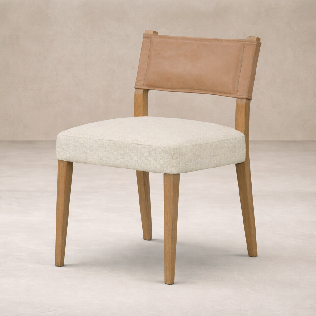 Side angle of the Roseto Dining Chair featuring a soft beige seat and a leather backrest.
