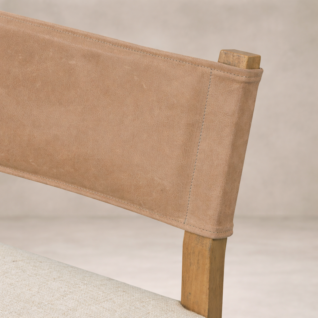 Detail of the Roseto Dining Chair's soft suede backrest and natural wood frame.