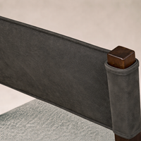 Detail of the Roseto Dining Chair showcasing its sleek gray upholstery and wooden accents.