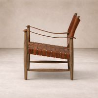 Side angle of the Marcella Accent Chair featuring a woven leather seat and sturdy wooden frame.