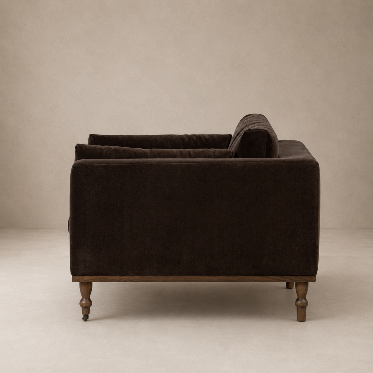 Brown velvet arm chair against a beige wall