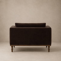Brown velvet chair against a beige background