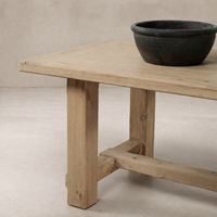 Detail of the Verona Weathered Pine Dining Table showcasing its rustic finish and sturdy legs.