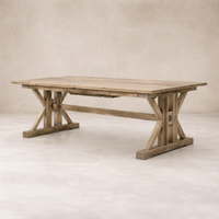 Side angle of the Positano Extension Dining Table showcasing its rustic wood finish and sturdy X-frame base.