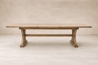 Side angle of the Positano Extension Dining Table, showcasing its rustic wood finish and sturdy trestle base.