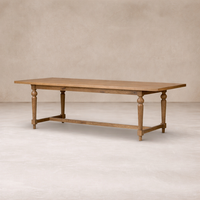 Side angle of the Menorca Extension Dining Table showcasing its rustic wood finish and elegant turned legs.