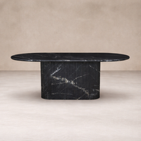Front view of the Elysia Dining Table, featuring a sleek oval top and elegant ribbed base in dark marble.