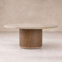 Front view of the Kaia Round Dining Table featuring a light stone top and textured brown base.