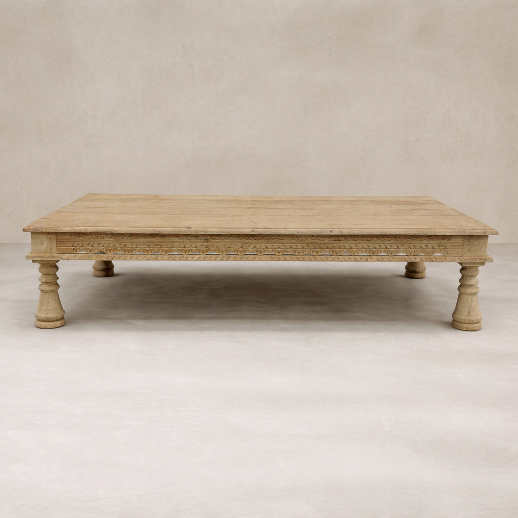 Front view of the Dharma Vintage Takhat Coffee Table featuring intricate carvings and sturdy turned legs.