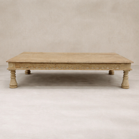 Front view of the Dharma Vintage Takhat Coffee Table featuring intricate carvings and sturdy turned legs.