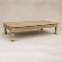 Three-quarter view of the Dharma Vintage Takhat Coffee Table showcasing intricate carvings and sturdy legs.