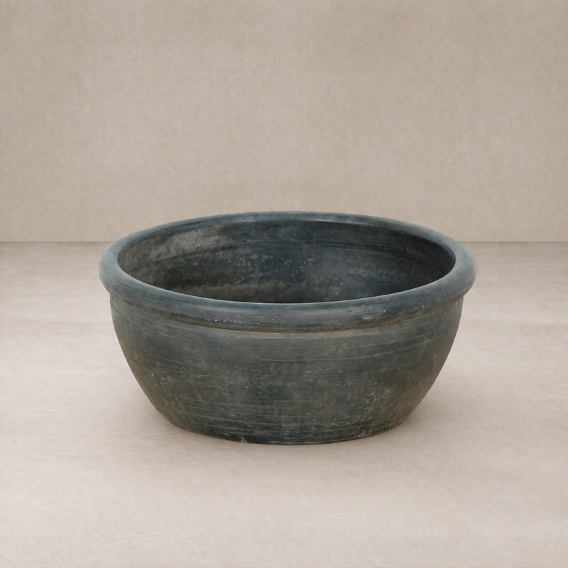Close-up of the Bohain Basin showcasing its rustic, dark finish and smooth, rounded shape.